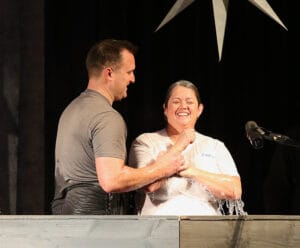 Pastor Mark baptizes a woman in the front of the church